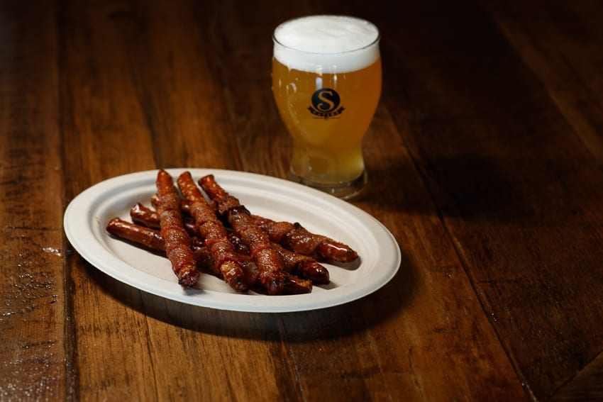 The Loaded Squirrel- Squirrel shafts with bacon. Beer in glass.