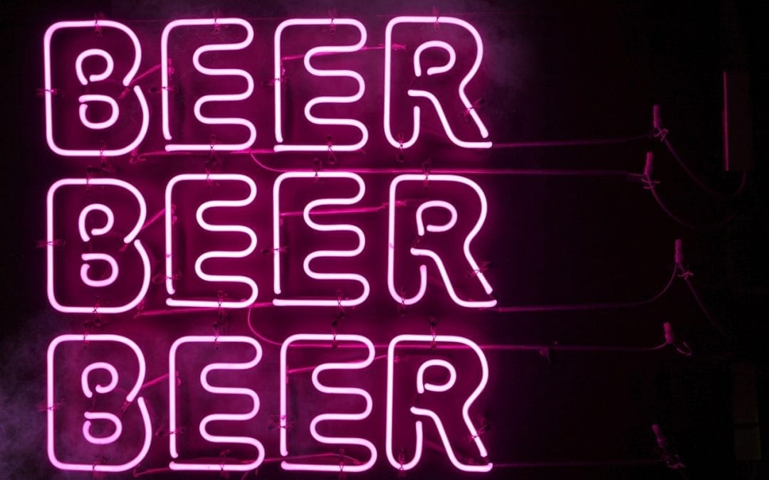 the word beer in pink neon