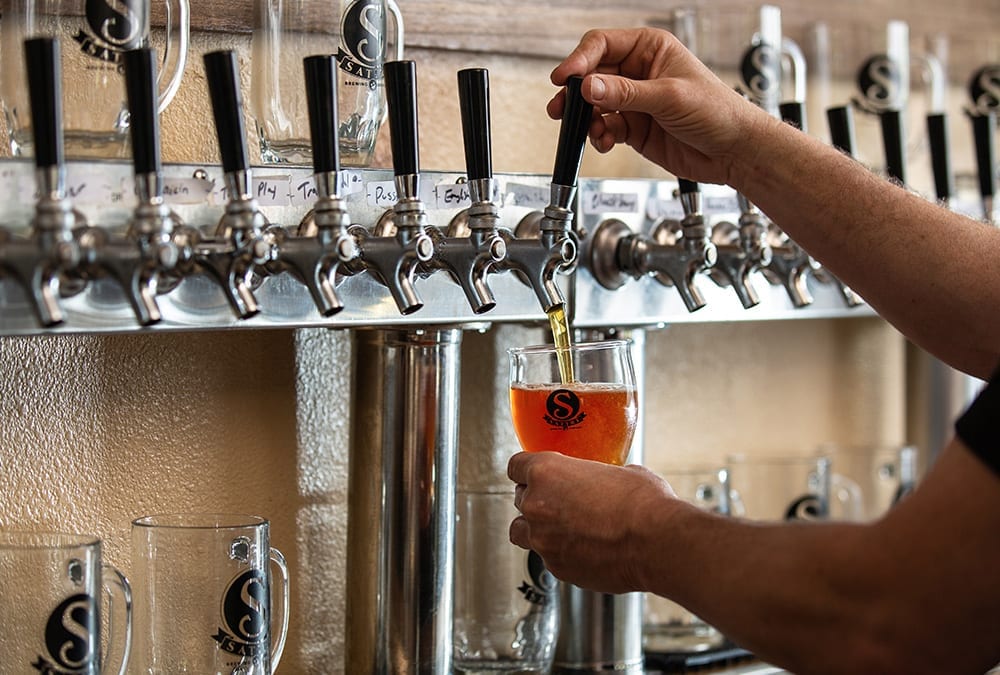Satire Brewing Company - Beer Pouring From Tap By Bartender.